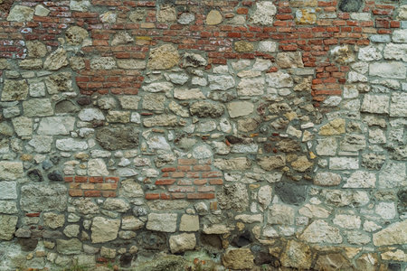 old stone background house wall closeup ,texture stacked of bricks and stonesの写真素材