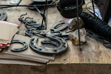 blacksmith's counter horseshoe on wooden table backgroundの写真素材