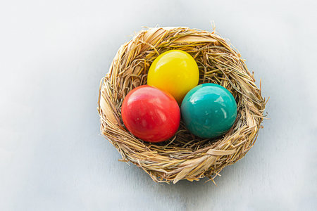 set of painted green and red eggs in basket design easterの写真素材
