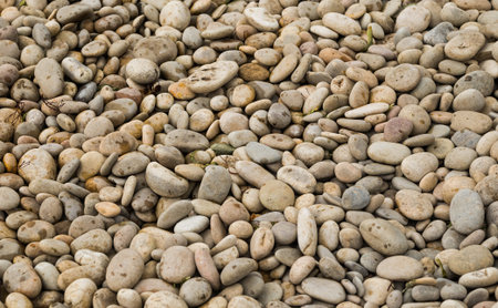 bank of the river is stone from a lot of gray pebbles, the background is stone close-upの写真素材