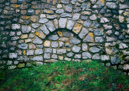 stone arch in the wall close up is made of stonesの写真素材