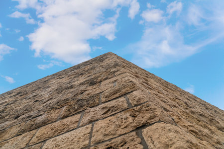 castle wall against the blue sky, protective wall made of stoneの写真素材