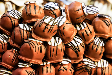 marzipan covered with dark chocolate glaze, confectionery counter with selective focusの写真素材