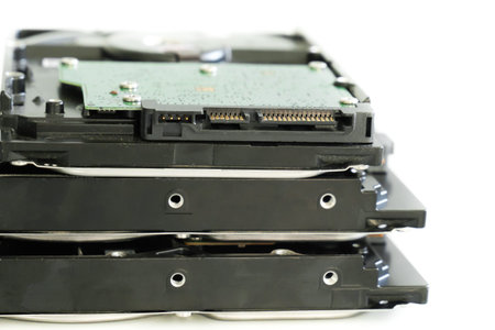 hdd disk with green microchip close-up stacked in a pile on isolated background