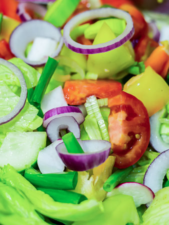 fresh lunch salad ring red onion lettuce tomatoes in a metal full bowl closeup useful snack dietの写真素材