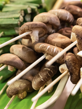 assorted mushroom skewers and vegetables on wooden skewers selective focusの写真素材