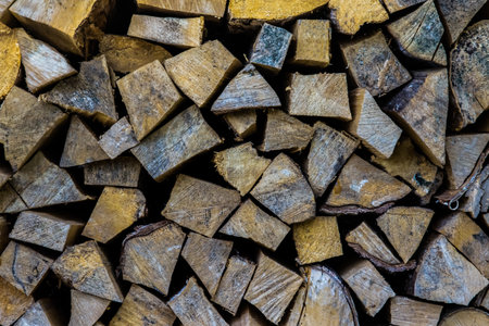 A pile of wood with many pieces of wood stacked on top of each otherの写真素材