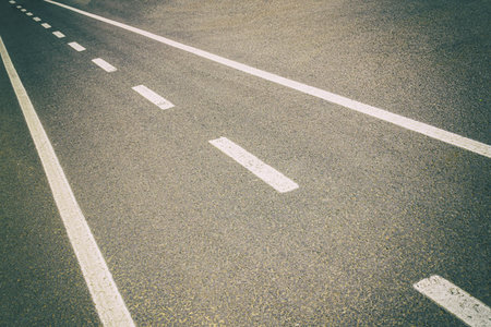 A road with white lines and no carsの写真素材