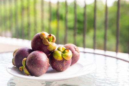 A plate of small purple fruits with green stems;の写真素材