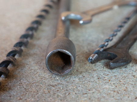 Three tools are shown on a gray surface. The first is a wrench, the second is a pair of pliers, and the third is a pair of clippers.の写真素材