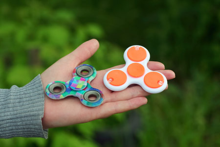 Fidget spinners in girl's handsの写真素材