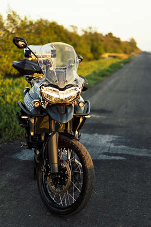 Samutprakran, Thailand - March 11, 2019 : triumph motorcycle new model 2018 triumph tiger xca on the road to beautiful sunset beach.