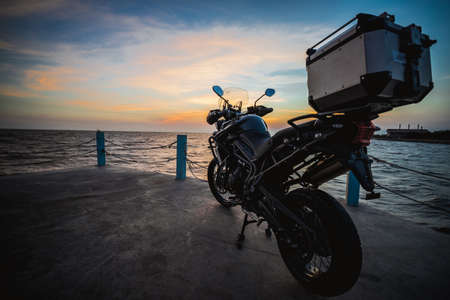 Samutprakran, Thailand - March 11, 2019 : triumph motorcycle new model 2018 triumph tiger xca on the road to beautiful sunset beach.のeditorial素材