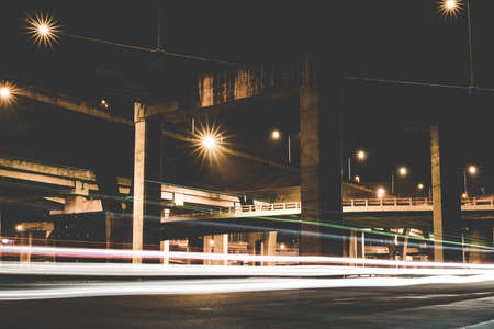 Street light painting, The tails of light made by moving cars in the night on the road.の写真素材