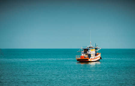 Beautiful sunrise,  Thai  Fishing boat is out fishing. Fishermen is a career that has been popular in the seaside city of Thailand.の写真素材
