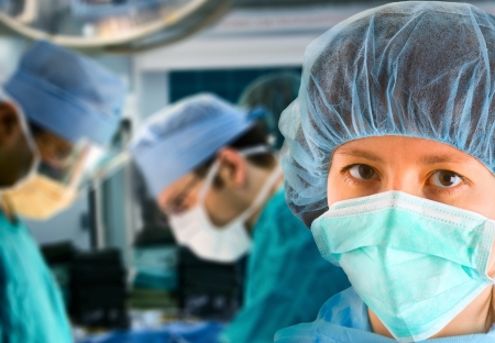 female surgeon with her surgical team on backgroundの写真素材