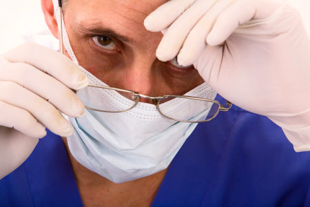Tired male doctor with spectacles