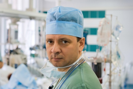 Tired male doctor in intensive care unitの写真素材