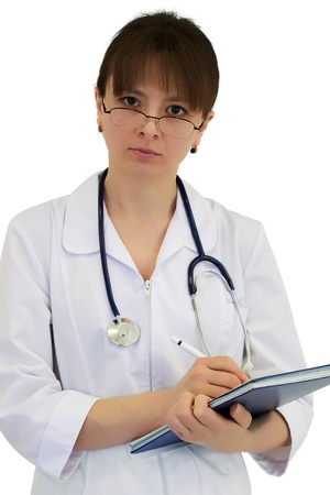 physician looking over spectacles and writing with penの写真素材