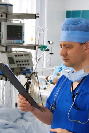 doctor in ICU reading prescriptionの写真素材