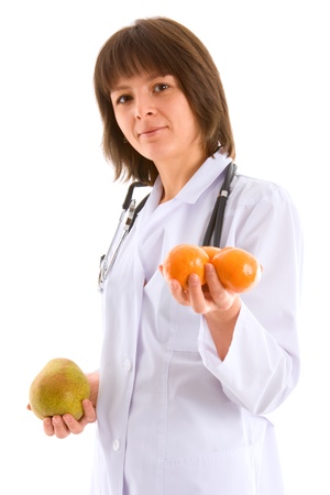 young female doctor with fruits in handsの写真素材