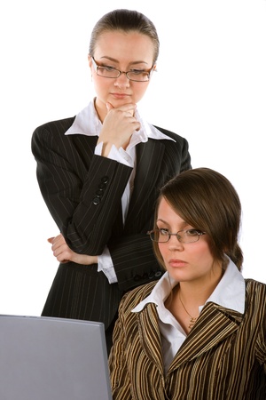 two young beautiful businesswomen with laptop solving a problemの写真素材