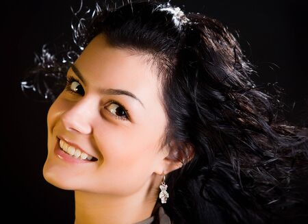 young attractive jewess woman with long hairs on black backgroundの写真素材
