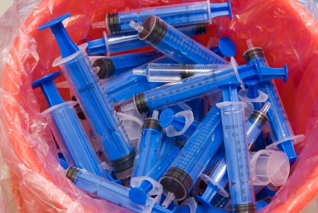 several syringes in recycle binの写真素材