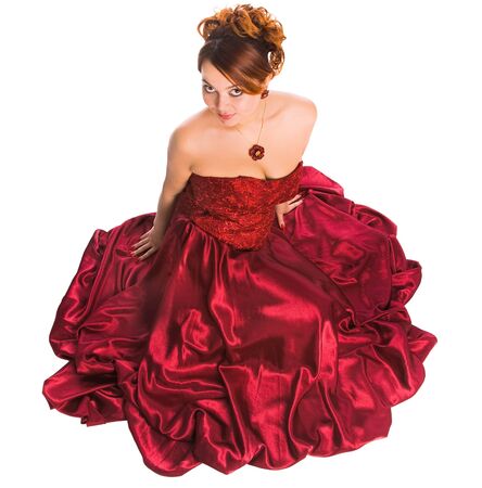 young attractive woman sitting in long red dress. view from abobe.の写真素材