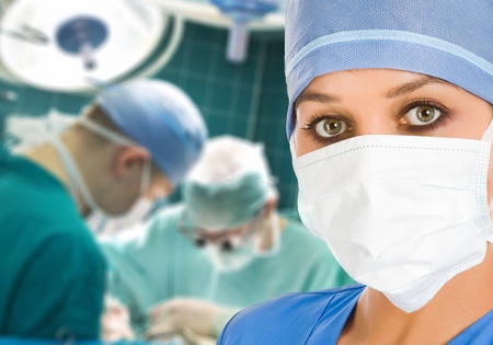 female doctor at operation room with surgeons on backgroundの写真素材