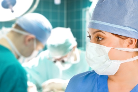 female surgeon with her surgical team on backgroundの写真素材