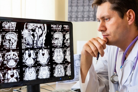 Doctor in hospital looking at ct scan の写真素材