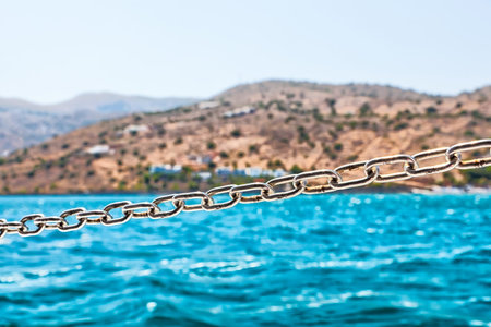 Steel Chain on the Sailing Boat with Coast at Background 