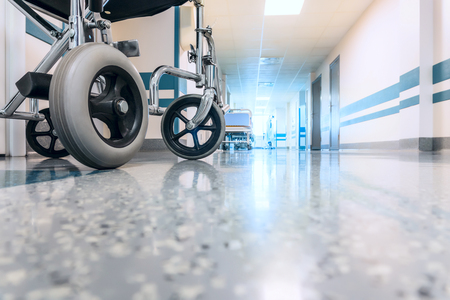 Empty Wheelchair Parked in Hospital Long Hallwayの写真素材