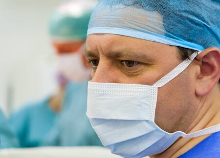 Male  experienced surgeon in operation room with his teamの写真素材