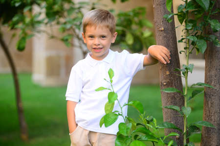 Portrait of young smiling boy in outdoors. Image with shallow DOF.の写真素材