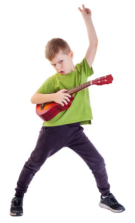 Cute boy playing the ukulele guitar isolated on white backgroundの写真素材