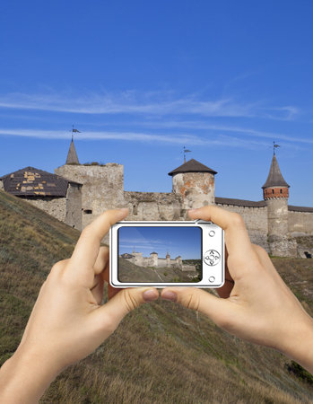 Abstract Camera  Tourist Holds Up Camera at Castle in Kamenets-Podolsky 