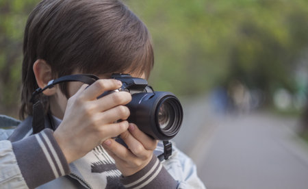 young photographer clicking photo from camera
