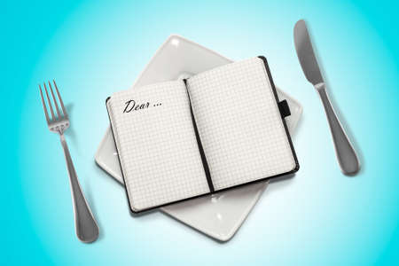 notebook on a plate and blue backgroundの写真素材