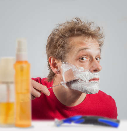 Man with shaving cream to his faceの写真素材