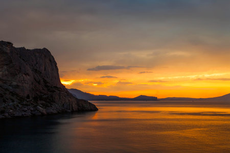 Golden sunset on the sea and mountain view