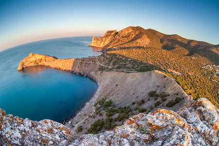 Mountain and sea landscape through fish eye lensの写真素材