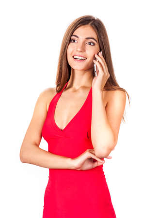 portrait of attractive young woman talking on the mobile phone isolated on white backgroundの写真素材