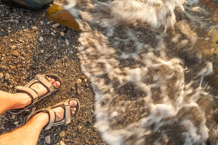 man feet on beach sandの写真素材