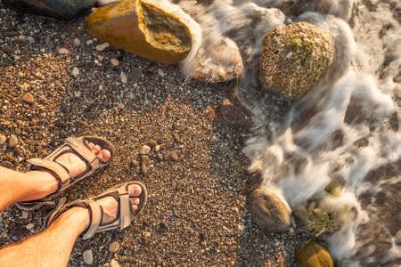 man feet on beach sandの写真素材
