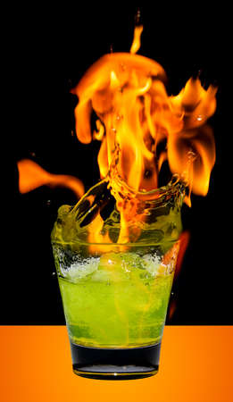 Glass with mojito splash and fireの写真素材