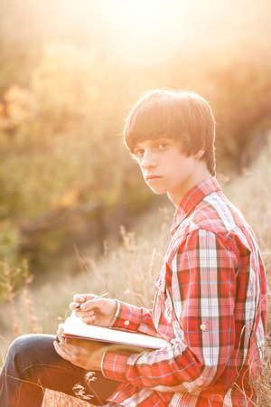 Young student working in city parkの写真素材