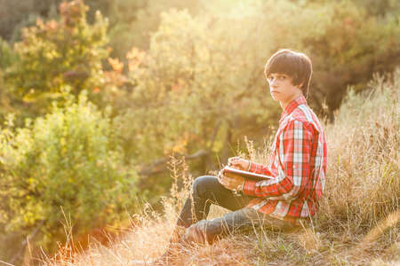 Young student working in city parkの写真素材
