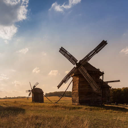 Traditional wooden ukrainian windmill in the fieldの写真素材